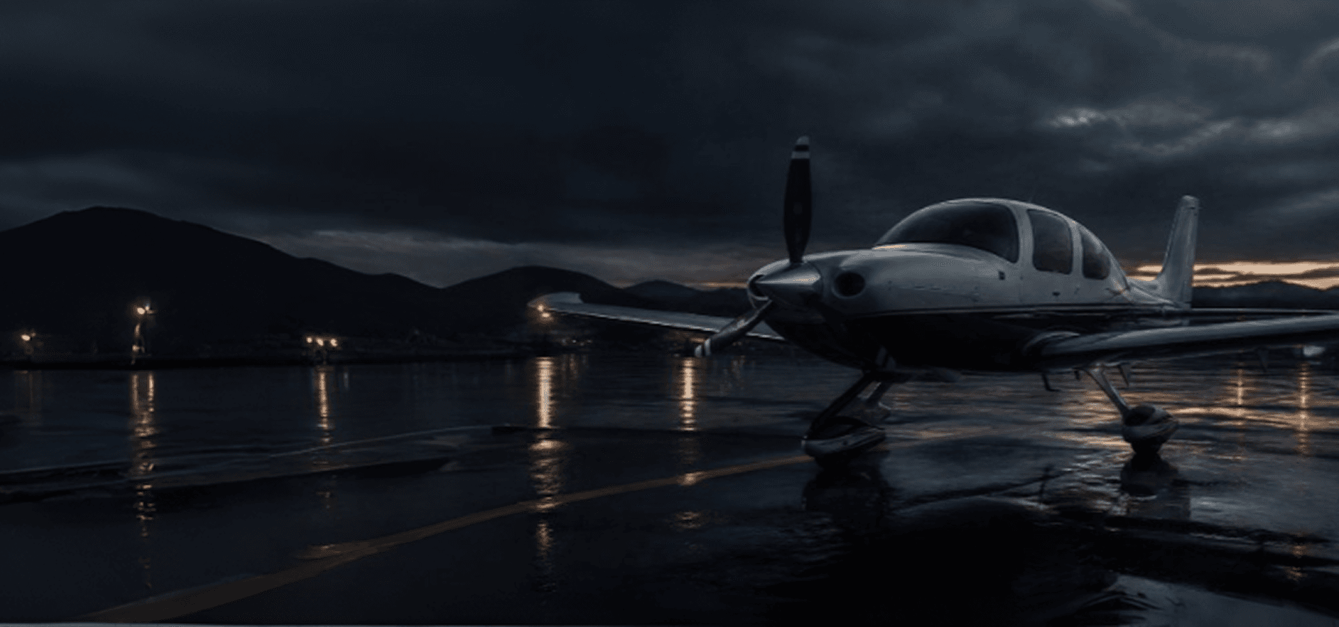 General aviation aircraft on a wet tarmac at dusk